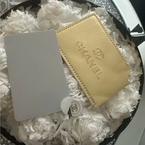 Chanel beauty mirror in elegant gold protective cover .